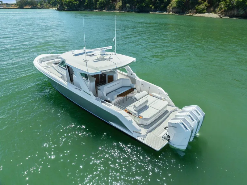 Slide: The Image of 2024 Tiara Yachts 48 LS luxury boat on serene water. - 8