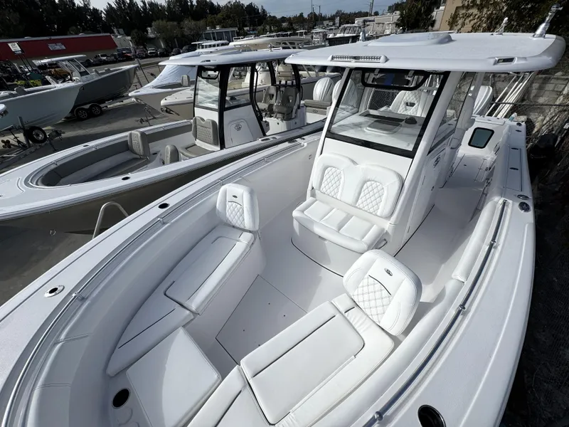 Slide: The Image of 2025 Sportsman Open 302 boat with sleek white interior and spacious seating. - 10