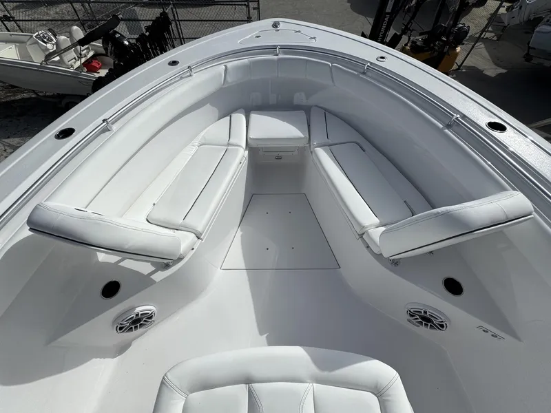 Slide: The Image of 2025 Sportsman Open 302 boat interior with white cushioned seating. - 11
