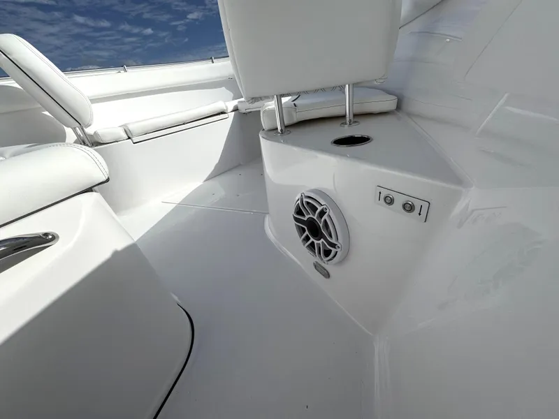 Slide: The Image of 2025 Sportsman Open 302 boat interior with white seating and built-in speaker. - 13
