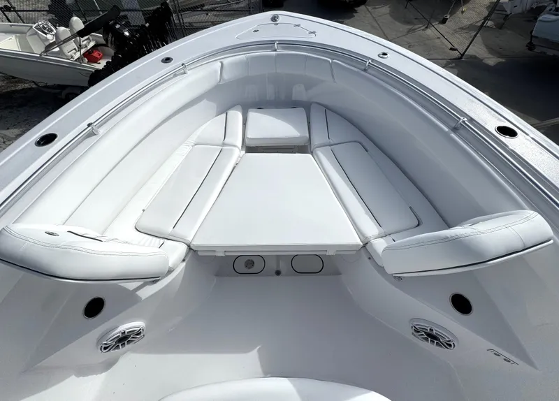 Slide: The Image of 2025 Sportsman Open 302 boat interior with white cushioned seating. - 14