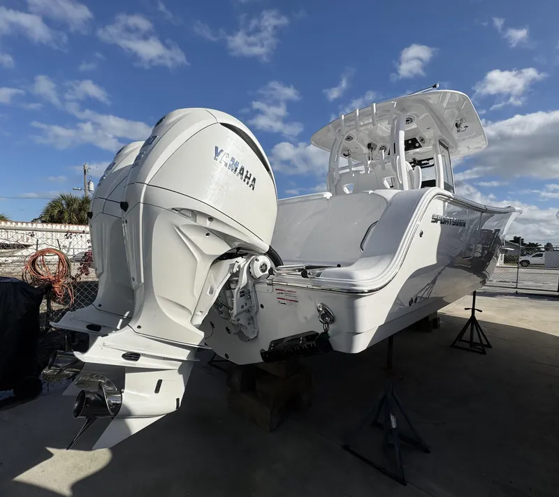 Slide: The Image of 2025 Sportsman Open 302 boat with Yamaha engine under clear blue sky. - 2