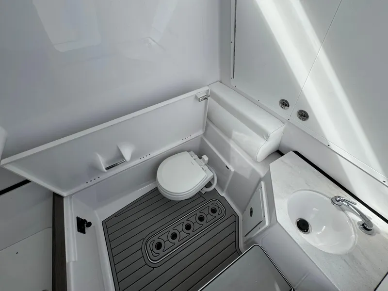 Slide: The Image of 2025 Sportsman Open 302 boat interior with toilet and sink. - 22