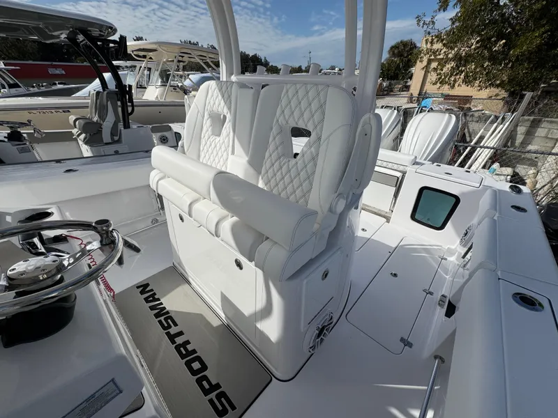 Slide: The Image of 2025 Sportsman Open 302 boat interior with white seating and steering wheel. - 23