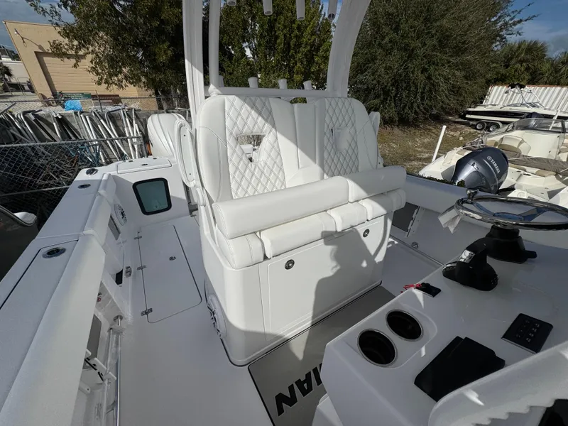 Slide: The Image of 2025 Sportsman Open 302 boat interior with white seating and control panel. - 24