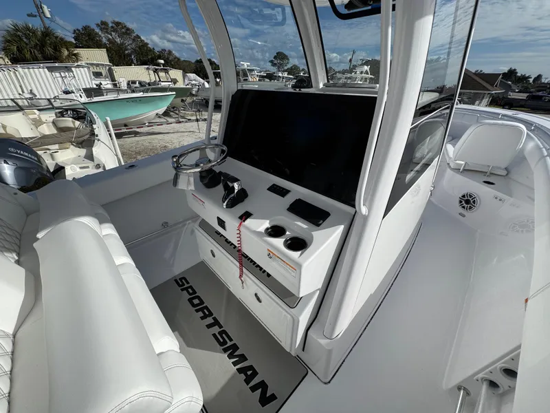Slide: The Image of 2025 Sportsman Open 302 boat interior with modern console and steering wheel. - 25