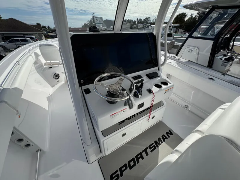Slide: The Image of 2025 Sportsman Open 302 boat cockpit with steering wheel and control panel. - 26