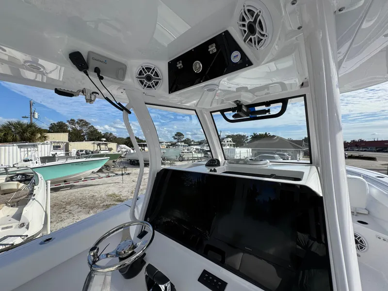 Slide: The Image of Interior view of 2025 Sportsman Open 302 boat, featuring modern dashboard and steering wheel. - 29