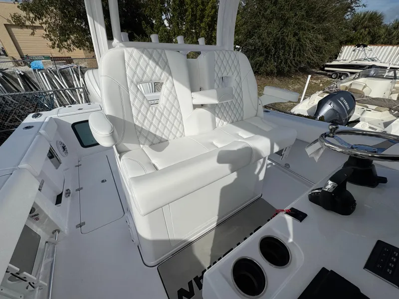 Slide: The Image of 2025 Sportsman Open 302 boat interior with white seating and steering console. - 30