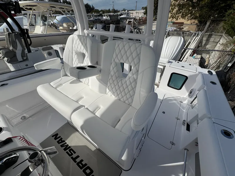 Slide: The Image of 2025 Sportsman Open 302 boat interior with white cushioned seating and modern design. - 31