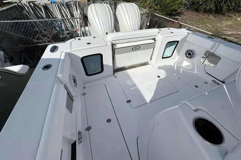 Slide: The Image of 2025 Sportsman Open 302 boat deck with storage compartments and seating. - 33