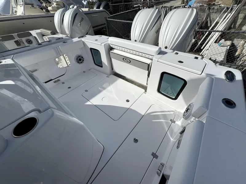 Slide: The Image of 2025 Sportsman Open 302 boat interior, spacious deck with storage and seating. - 34
