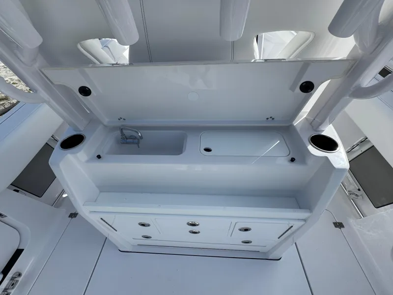 Slide: The Image of 2025 Sportsman Open 302 boat interior with sink and storage compartments. - 36