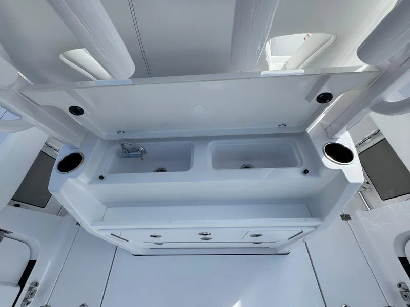 Slide: The Image of 2025 Sportsman Open 302 boat interior with dual sinks and storage. - 37