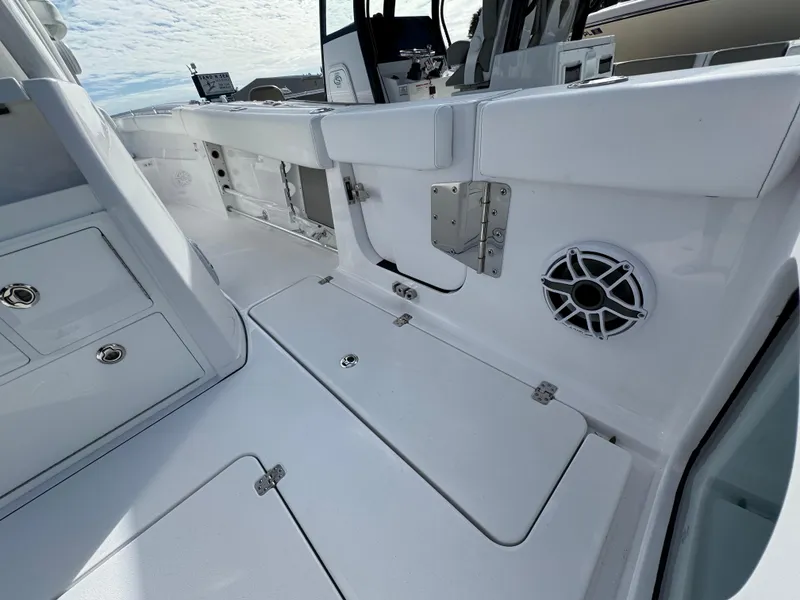 Slide: The Image of 2025 Sportsman Open 302 boat interior with sleek white design and storage compartments. - 40
