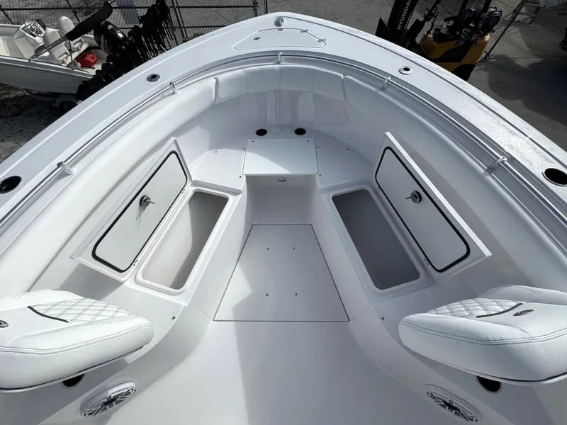 Slide: The Image of 2025 Sportsman Open 302 boat interior with storage compartments and seating. - 7