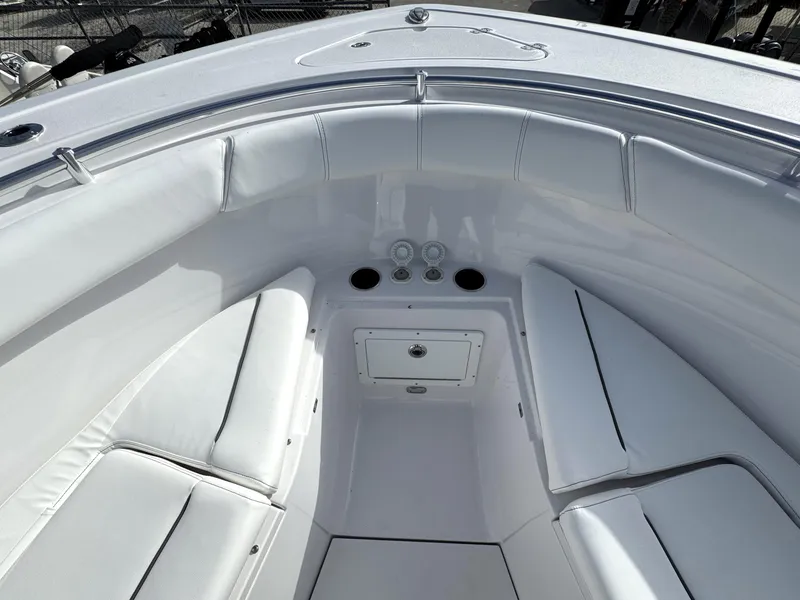 Slide: The Image of 2025 Sportsman Open 302 boat interior with white cushioned seating. - 8