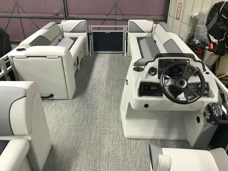 Slide: The Image of 2025 Avalon Venture Cruise Rear Bench boat interior with modern seating and steering console. - 14