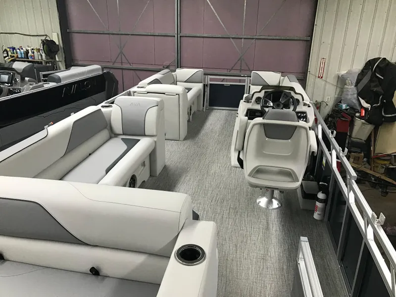 Slide: The Image of 2025 Avalon Venture Cruise Rear Bench pontoon boat interior with modern seating and helm. - 16