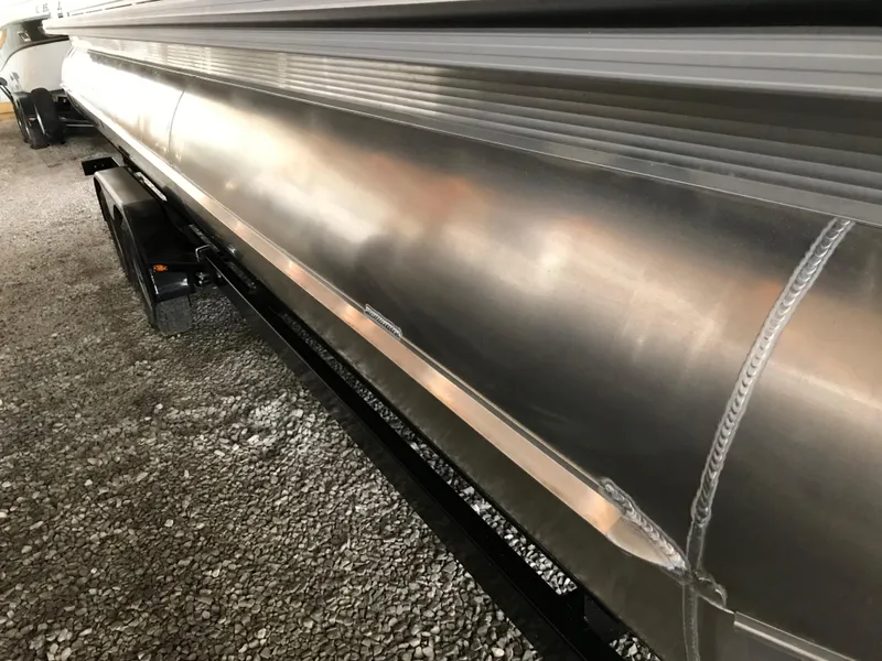 Slide: The Image of 2025 Avalon Venture Cruise pontoon boat, side view, showcasing sleek aluminum design. - 20