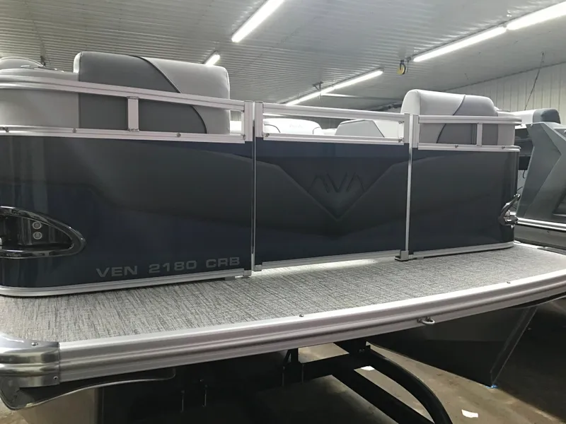 Slide: The Image of 2025 Avalon Venture Cruise Rear Bench pontoon boat in a showroom setting. - 6