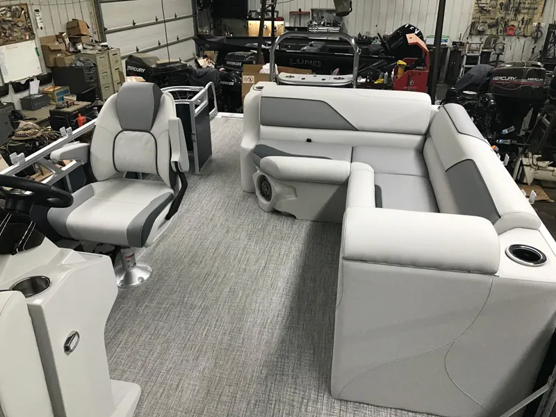 Slide: The Image of 2025 Avalon Venture Cruise Rear Bench boat interior with gray seating and steering console. - 8