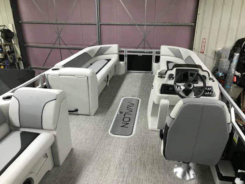 Slide: The Image of 2025 Avalon VENTURE 2585 Versatile Rear Bench pontoon boat in a showroom. - 14