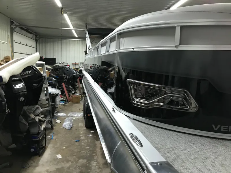 Slide: The Image of 2025 Avalon VENTURE 2585 pontoon boat on trailer, rear view, gravel background. - 2