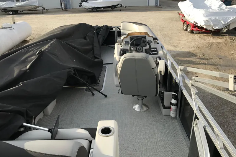Slide: The Image of 2025 Avalon VENTURE 2585 VERSATILE REAR BENCH interior with covered seating and steering console. - 27