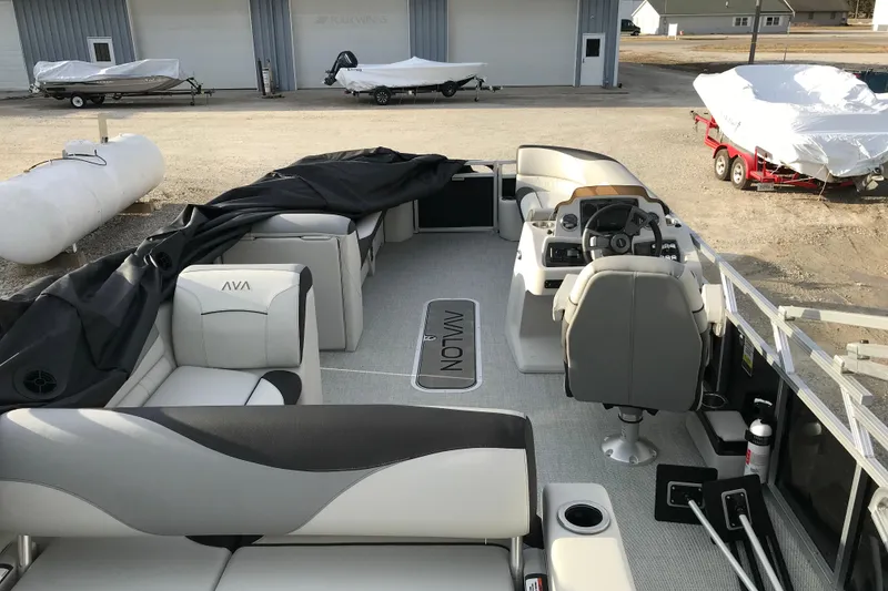 Slide: The Image of 2025 Avalon Venture 2585 Versatile Rear Bench boat interior with seating and steering console. - 38