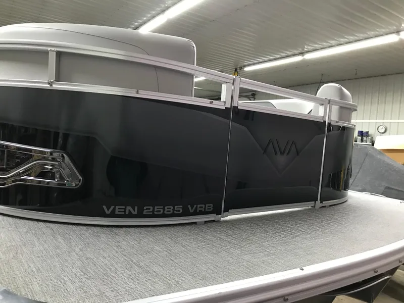 Slide: The Image of 2025 Avalon VENTURE 2585 Versatile Rear Bench pontoon boat in a showroom. - 9