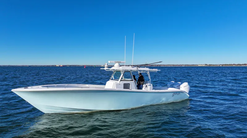 Slide: The Image of 2024 Yellowfin 39 boat cruising on open water under clear blue sky. - 0