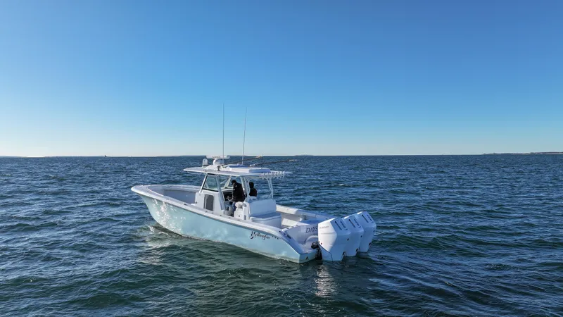 Slide: The Image of 2024 Yellowfin 39 boat cruising on open water under clear blue sky. - 1