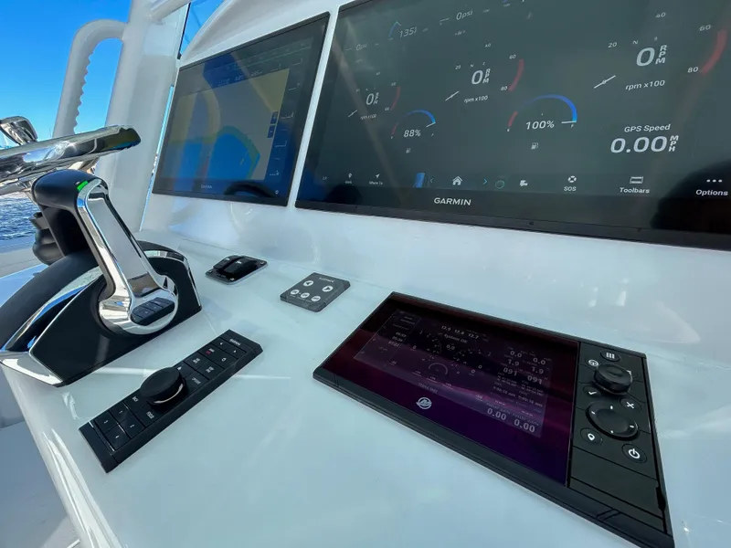 Slide: The Image of 2024 Yellowfin 39 boat dashboard with advanced Garmin navigation displays. - 12