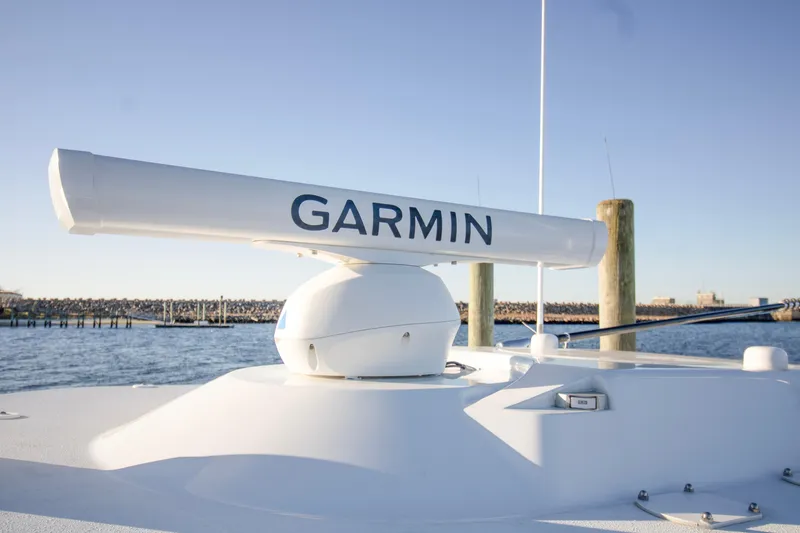 Slide: The Image of 2024 Yellowfin 39 boat with Garmin radar on deck, docked by the water. - 19
