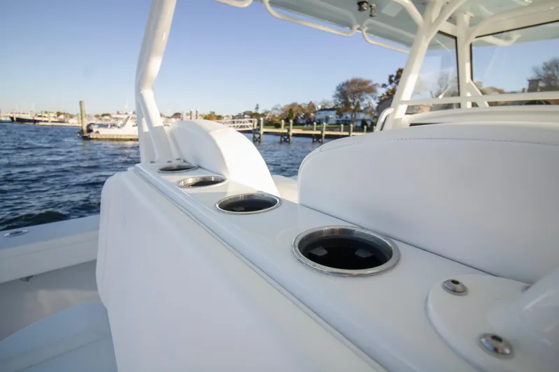 Slide: The Image of 2024 Yellowfin 39 boat interior with cup holders, docked by the water. - 20