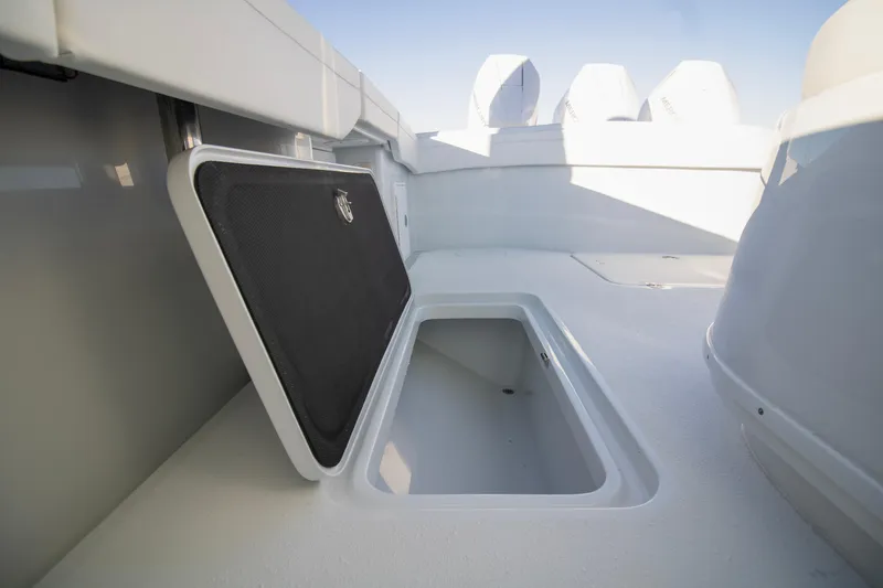 Slide: The Image of 2024 Yellowfin 39 boat storage compartment, open hatch, white interior. - 22