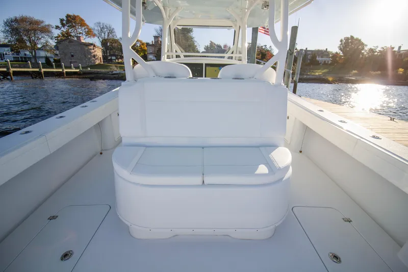 Slide: The Image of 2024 Yellowfin 39 boat interior with white seating, dockside view. - 25