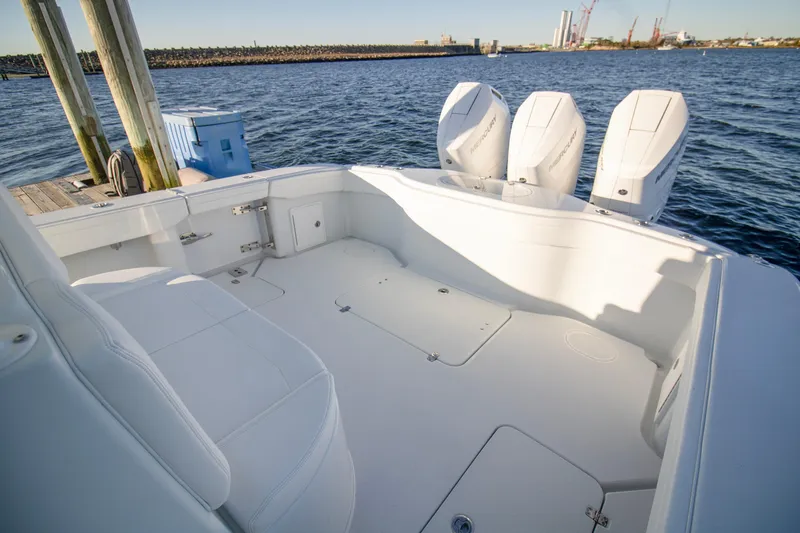 Slide: The Image of 2024 Yellowfin 39 boat with triple outboard engines on calm water. - 26