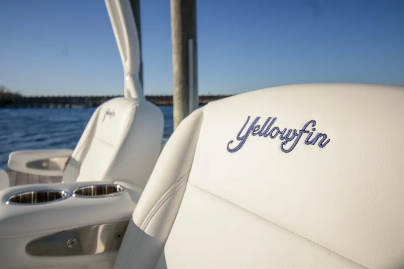 Slide: The Image of 2024 Yellowfin 39 boat seats with embroidered logo, near water. - 27