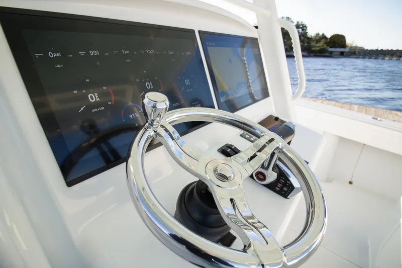Slide: The Image of 2024 Yellowfin 39 boat dashboard with modern steering wheel and digital displays. - 30