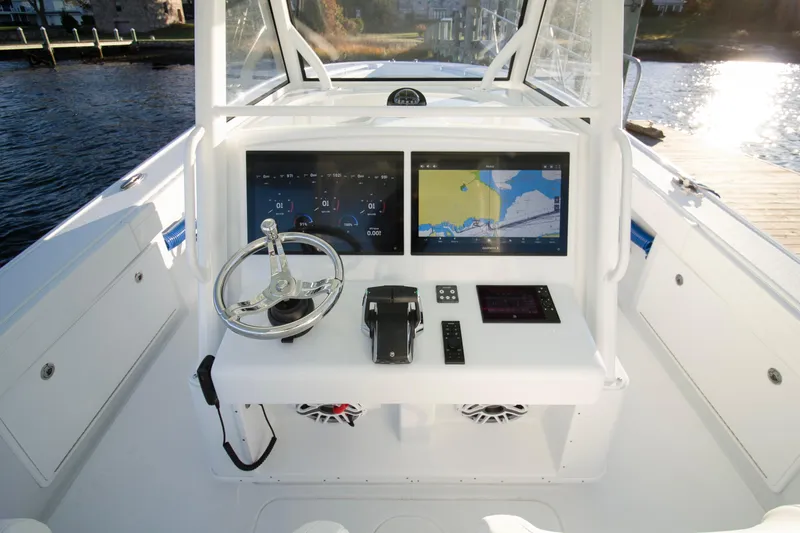 Slide: The Image of 2024 Yellowfin 39 boat dashboard with dual navigation screens and steering wheel. - 31