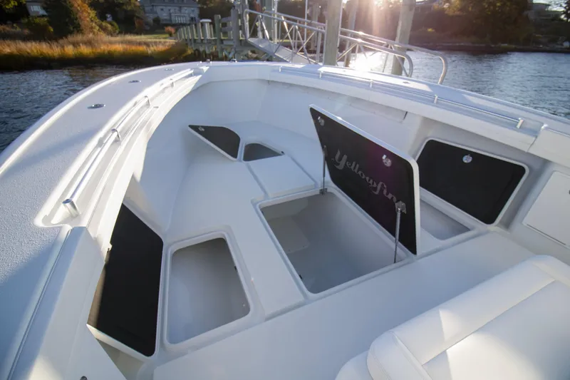 Slide: The Image of 2024 Yellowfin 39 boat interior with open storage compartments on a sunny day. - 42