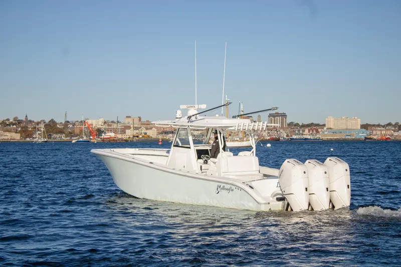 Slide: The Image of 2024 Yellowfin 39 boat with triple engines cruising on open water. - 6
