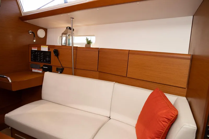 Slide: The Image of Interior of 2020 Jeanneau Sun Odyssey 389 yacht with white sofa and red cushion. - 11