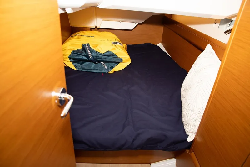 Slide: The Image of Cozy cabin interior of 2020 Jeanneau Sun Odyssey 389 sailboat with bed and pillow. - 12