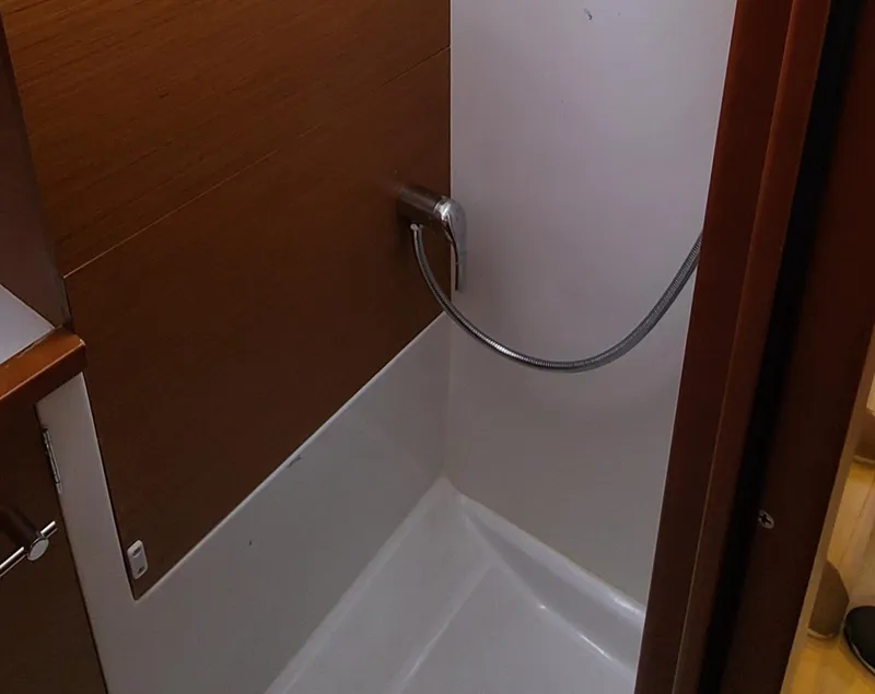 Slide: The Image of Shower area in 2020 Jeanneau Sun Odyssey 389 sailboat, featuring sleek wood paneling. - 14