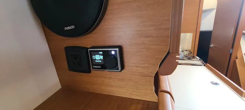 Slide: The Image of Control panel and speaker in 2020 Jeanneau Sun Odyssey 389 interior. - 15