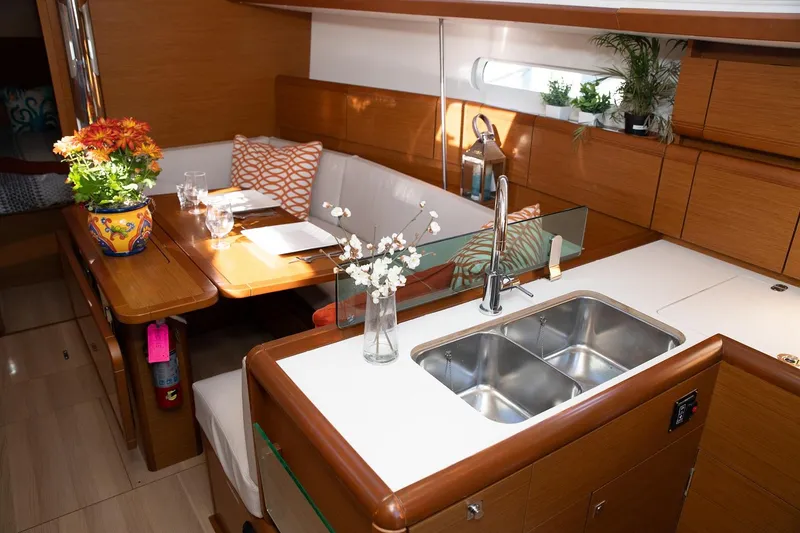 Slide: The Image of Interior of 2020 Jeanneau Sun Odyssey 389 yacht with modern kitchen and dining area. - 7