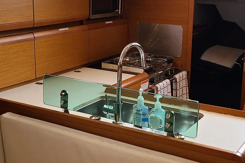 Slide: The Image of Jeanneau Sun Odyssey 389 yacht kitchen with sink and wooden cabinetry, 2020 model. - 8